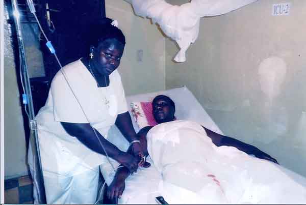Nurse in Ganta Hospital administering drip meds to patient